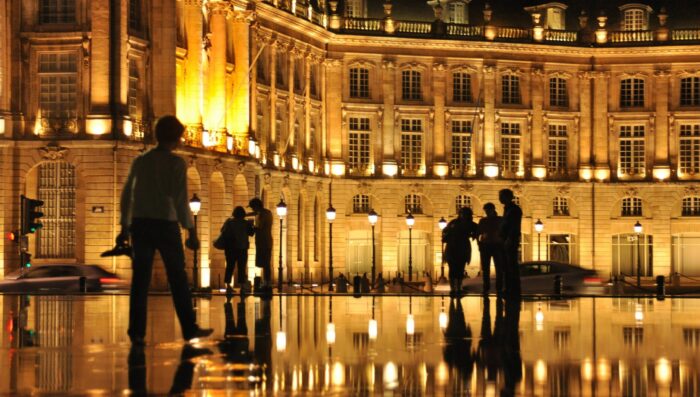 people in bordeaux at night, france