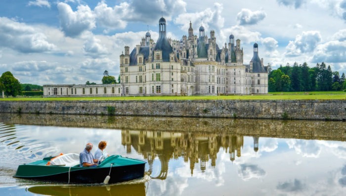 Couple in boat near french castle in Loire